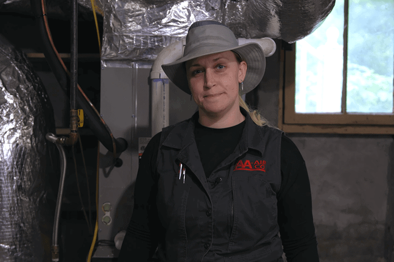 Erin in front of a duct system